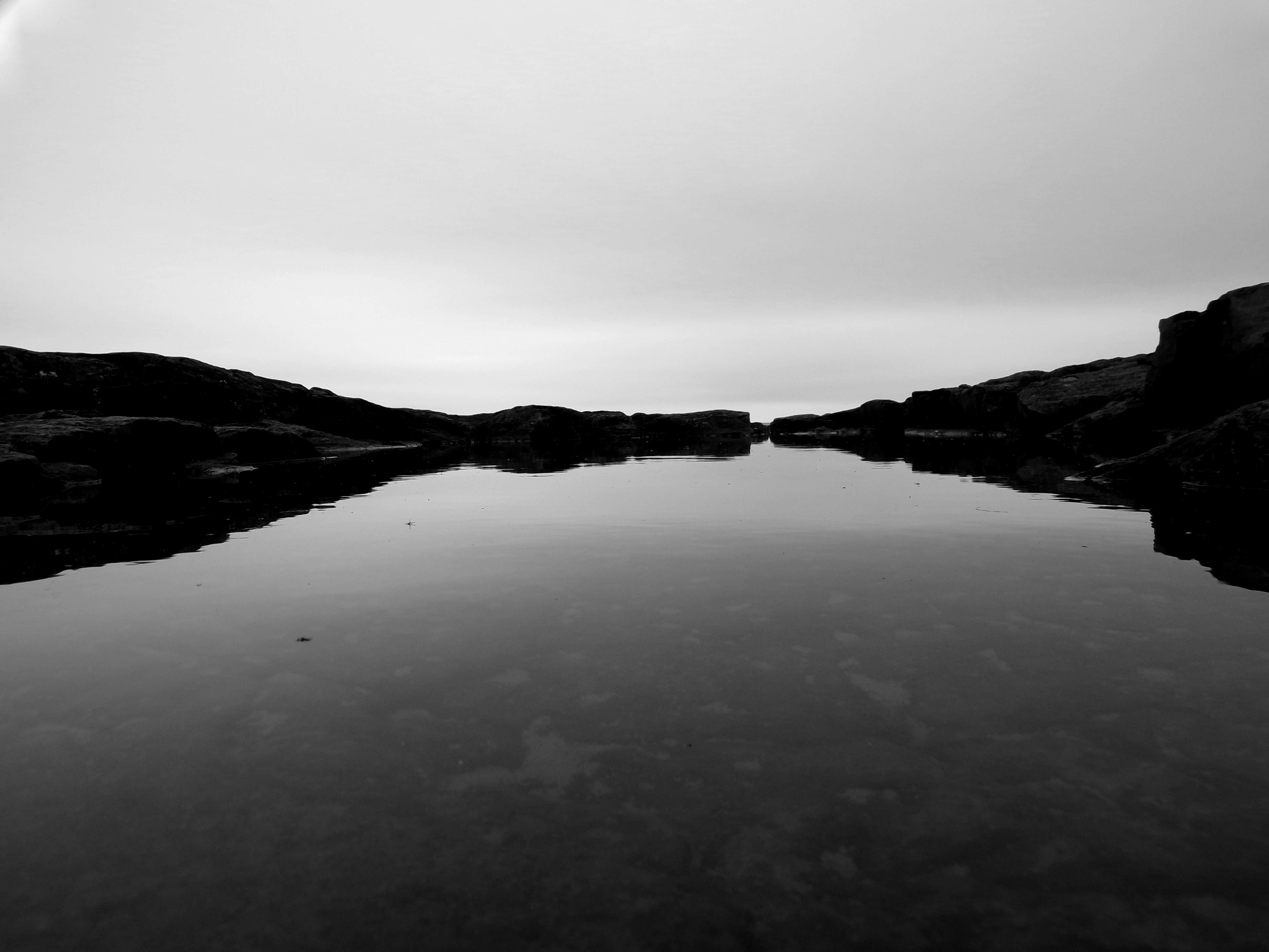 A puddle of water surrounded by rocks